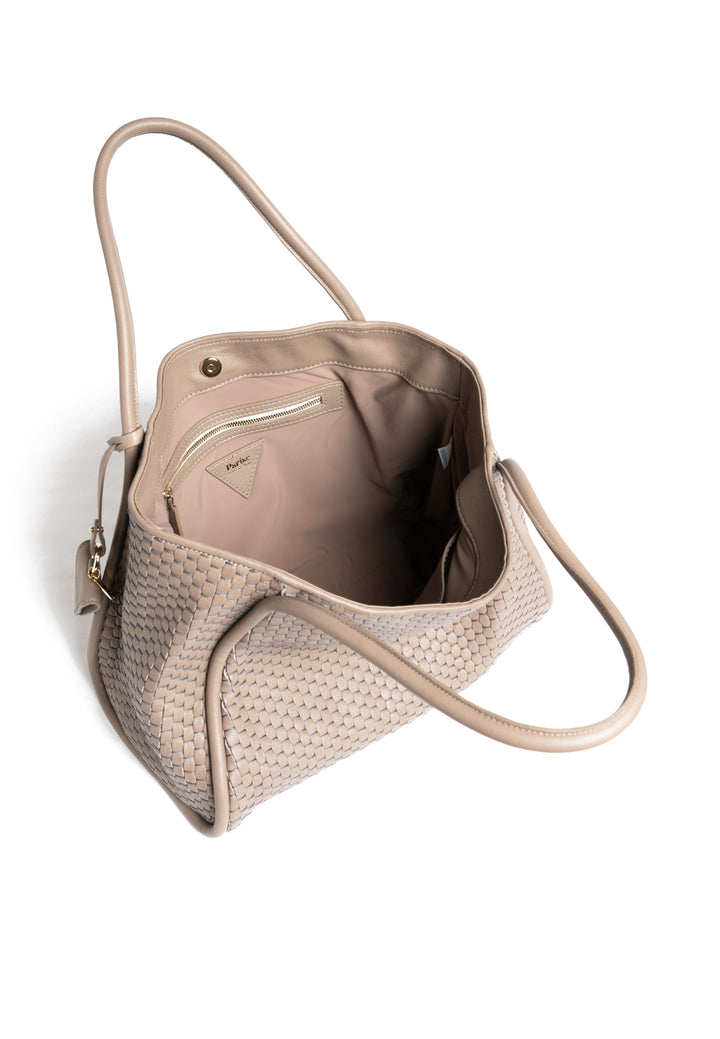 Woven beige handbag with long handles and attached accessory on white background.