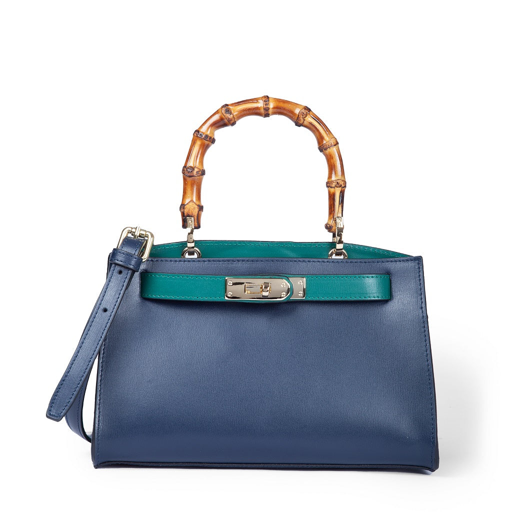 Elegant blue leather handbag with bamboo handle and green accents