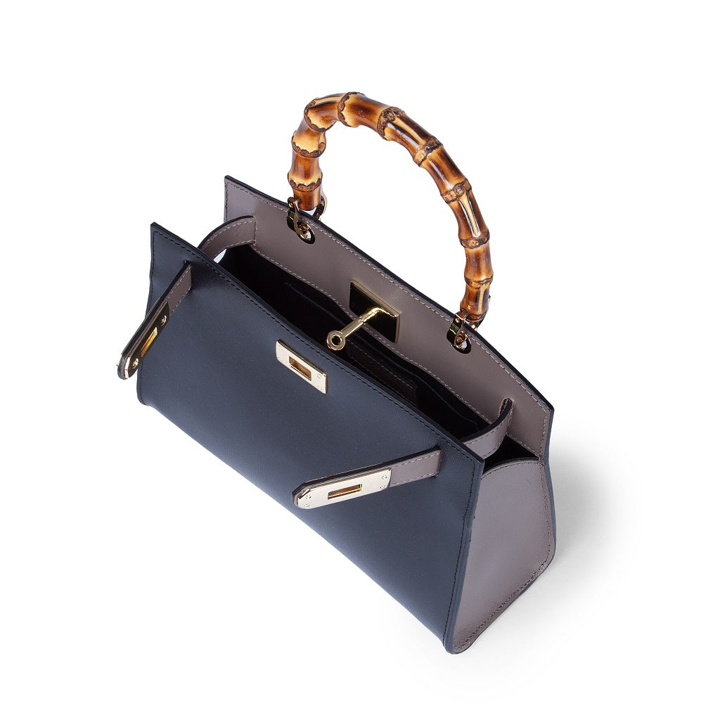 Elegant black handbag with bamboo handle and gold hardware