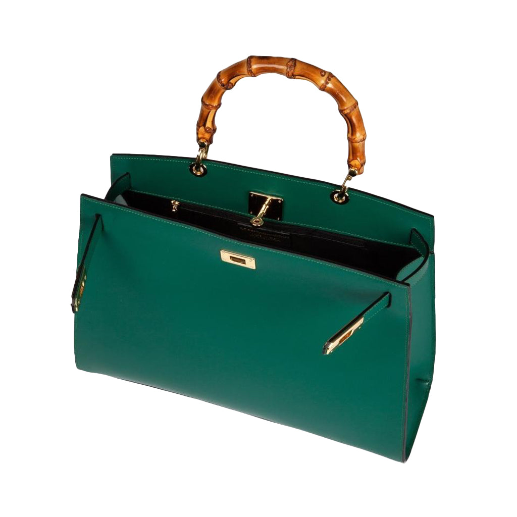 Green handbag with bamboo handle and gold accents on white background