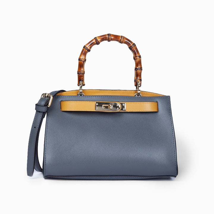 Stylish blue handbag with bamboo handles and a yellow accent