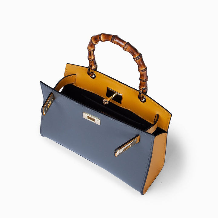 Luxury handbag with bamboo handle and gold accents