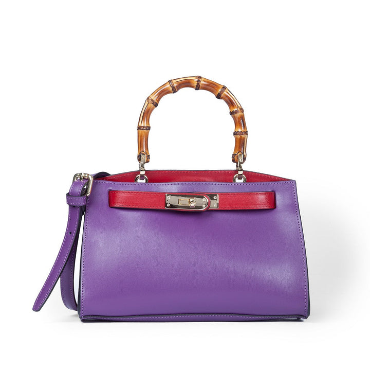 Purple leather handbag with a bamboo handle and red accents