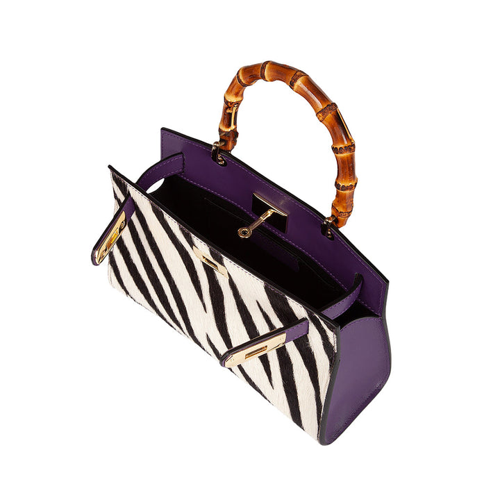 Black and white zebra print handbag with bamboo handle and purple interior