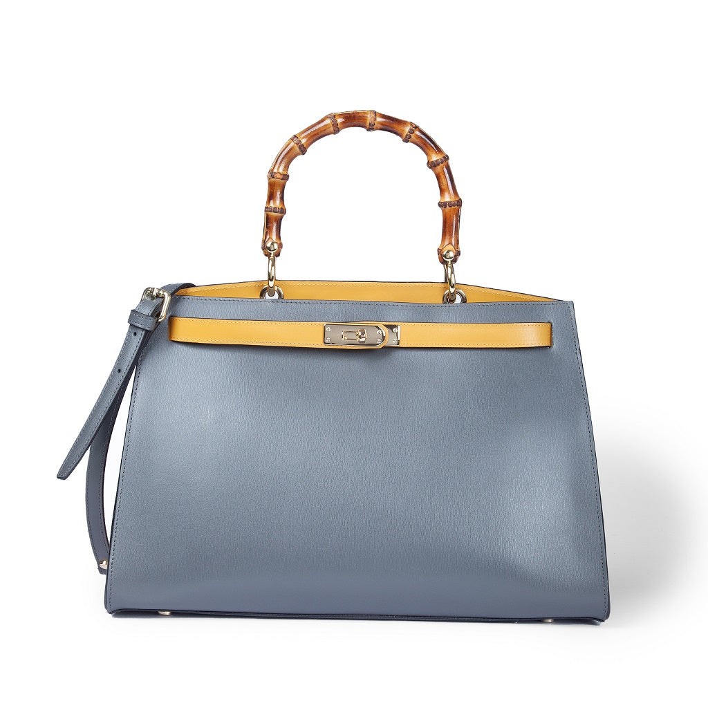 Blue leather handbag with bamboo handle and yellow accent