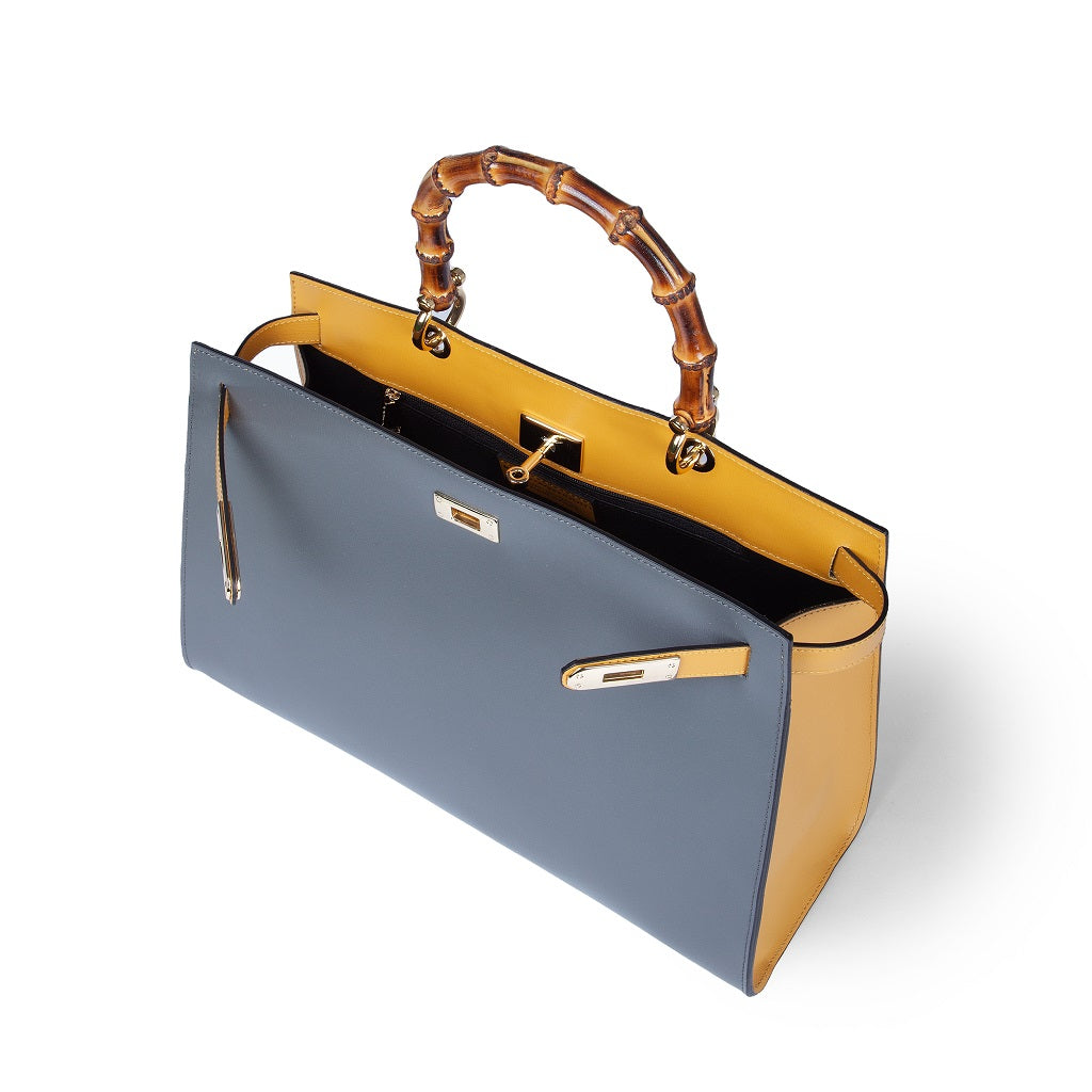 Luxury handbag with bamboo handle, featuring a sleek grey and yellow color scheme