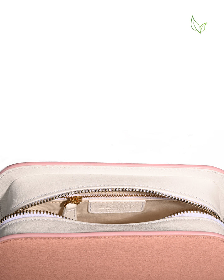 Pink and white zippered bag with gold accents