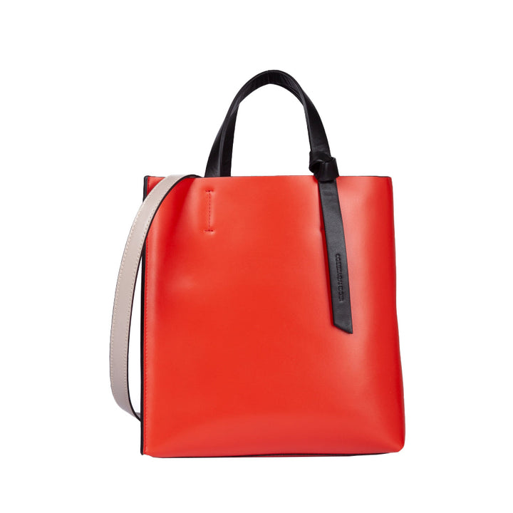 Bright red designer handbag with black handles and white shoulder strap