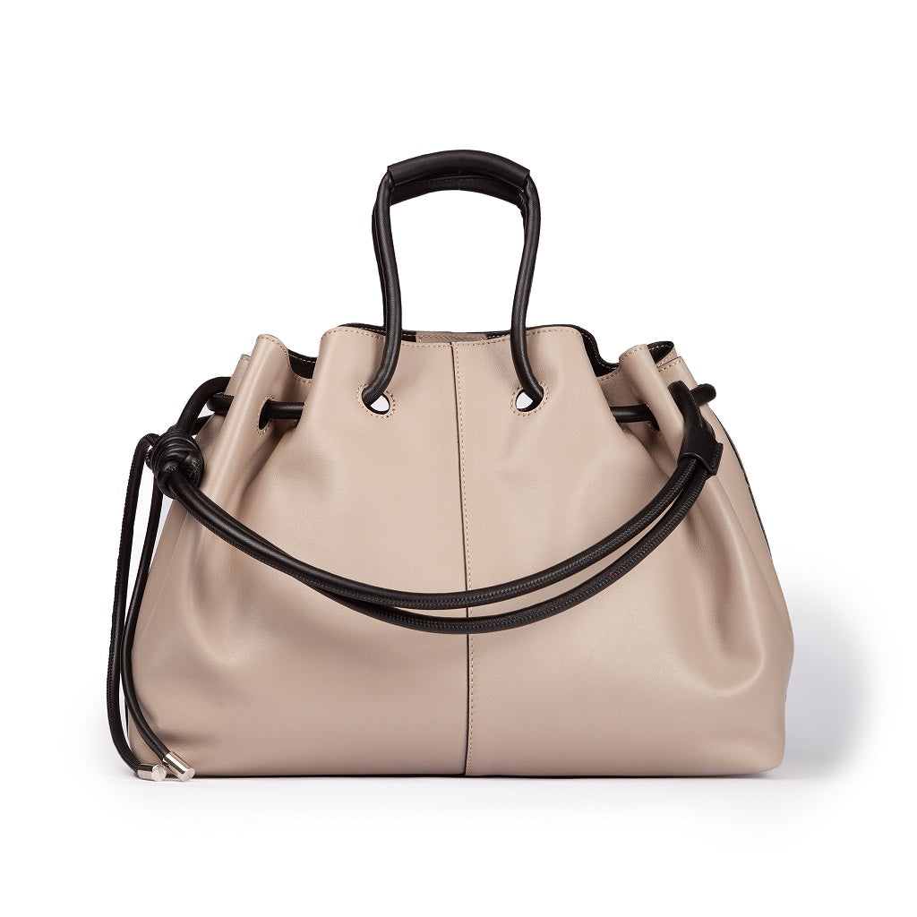 Beige leather handbag with black handles and drawstring closure on white background