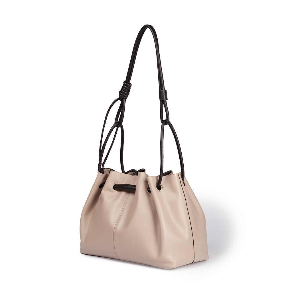 Beige leather bucket bag with black drawstring handles