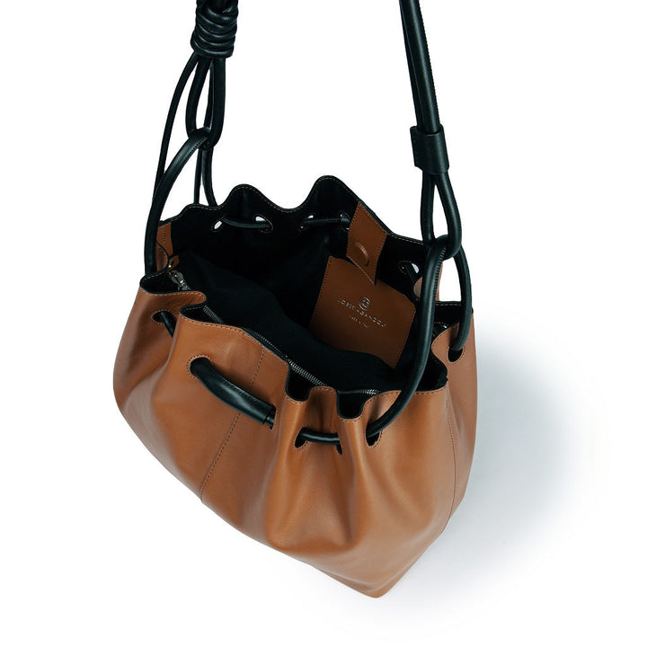 Brown leather drawstring handbag with black handles, top view