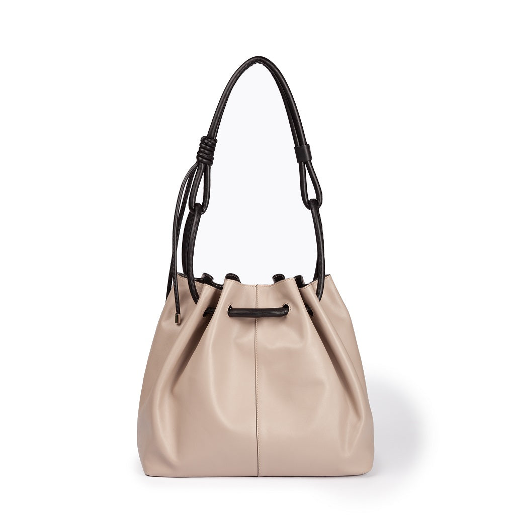 Beige leather bucket bag with black shoulder strap