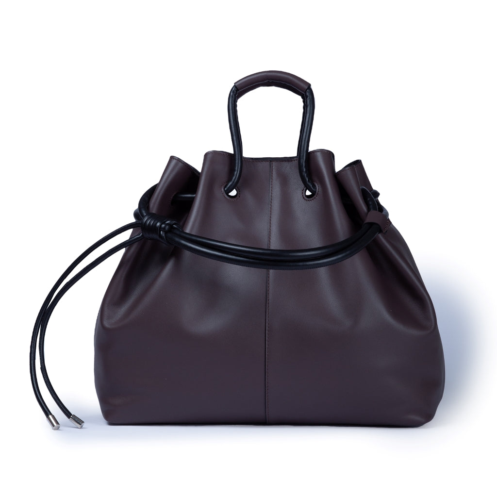 Dark brown leather handbag with knot handles and a drawstring closure