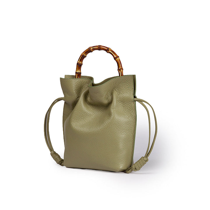 Olive green leather handbag with bamboo handle and drawstring sides