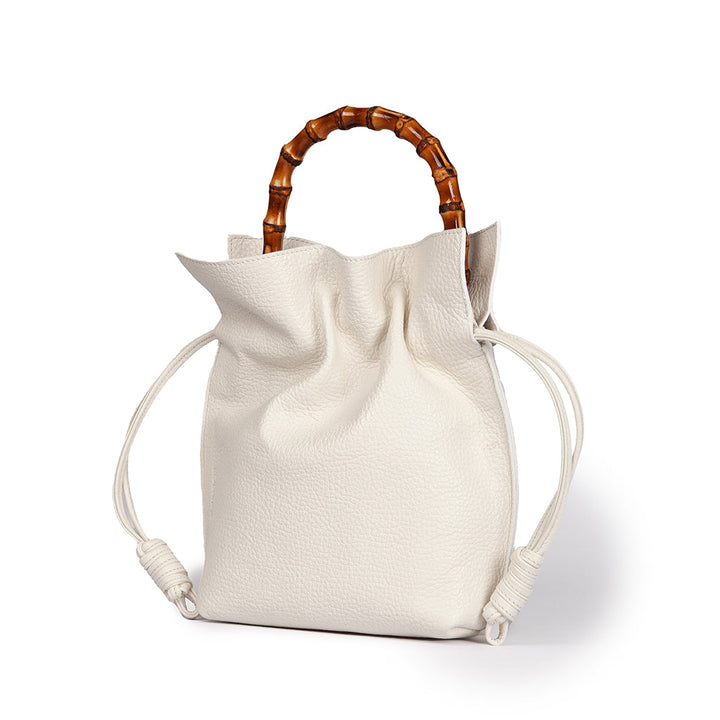 White leather handbag with bamboo handles and drawstring closure