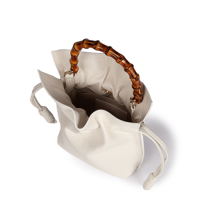 White leather handbag with bamboo handle and drawstring closure