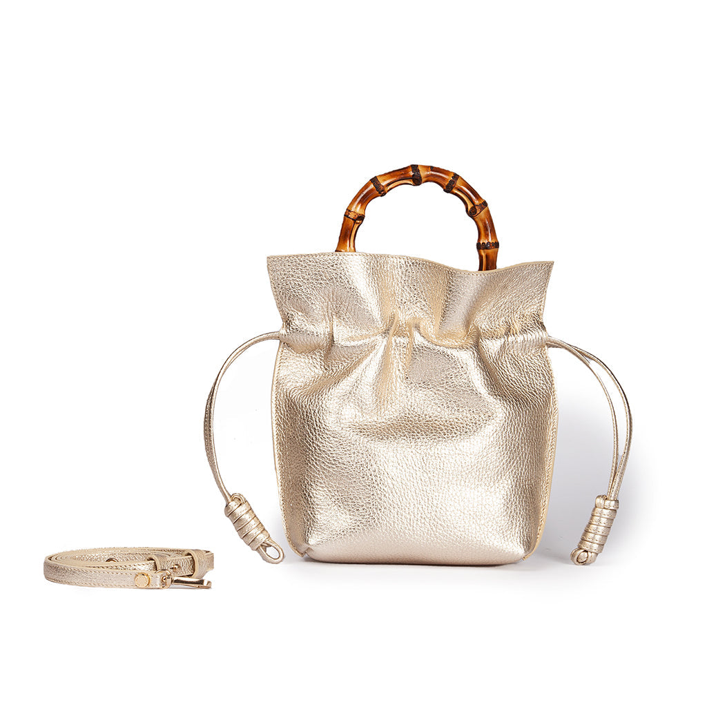 Gold handbag with bamboo handle and detachable strap