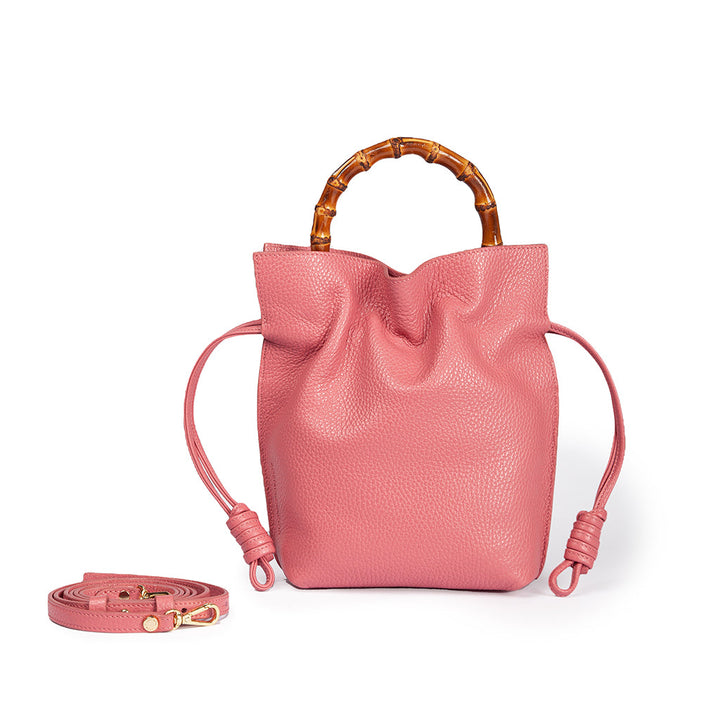 Pink leather handbag with bamboo handle and removable strap