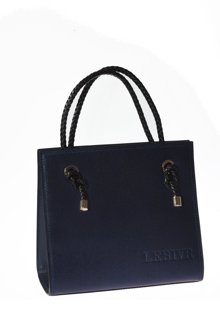 Elegant navy blue leather handbag with braided black handles and brand logo embossed