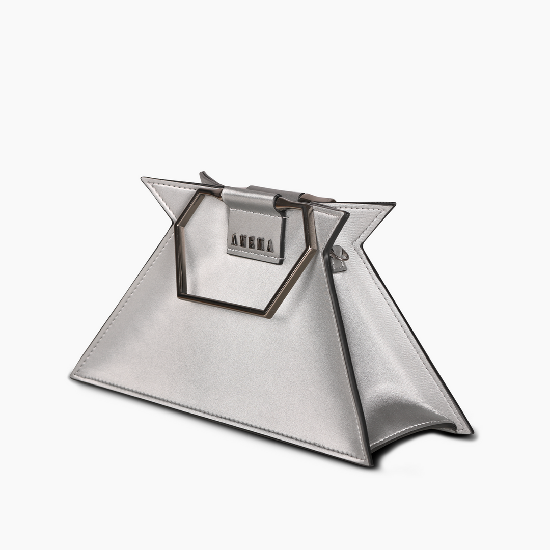 Silver geometric handbag with metallic handles on a white background