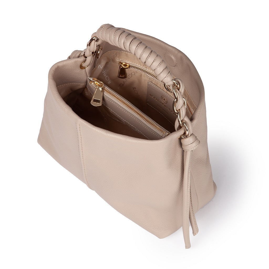 Beige leather handbag with open compartments and gold zippers