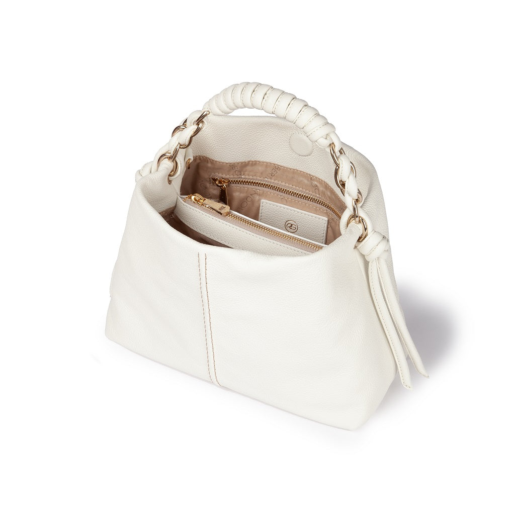 White leather handbag with a braided handle and open top showing interior compartments