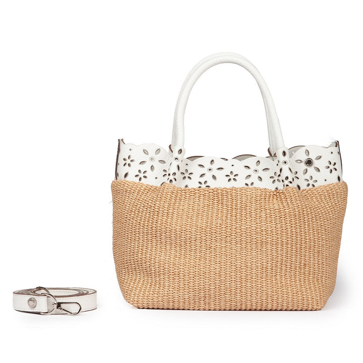 Straw tote bag with white floral cutout handles and detachable white strap