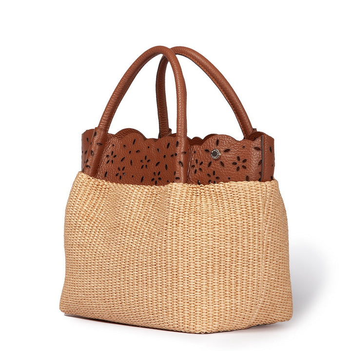 Tan woven handbag with brown leather handles and floral cutout design