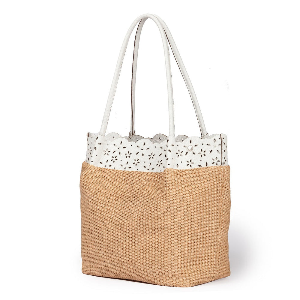 Tan and white woven tote bag with a floral cutout design on top