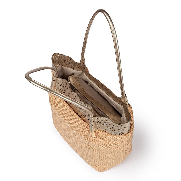 Tan woven handbag with silver straps and laser-cut detailing, top view