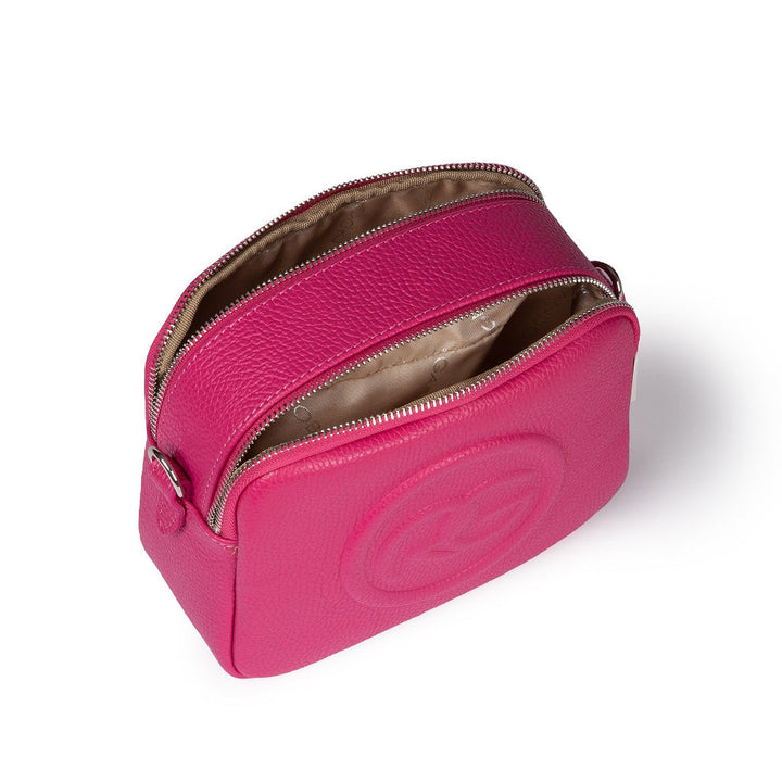 Bright pink leather crossbody bag with a double zipper and interior compartments