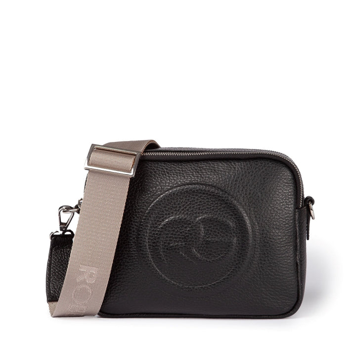 Black leather crossbody bag with beige adjustable strap and embossed circular logo in the center