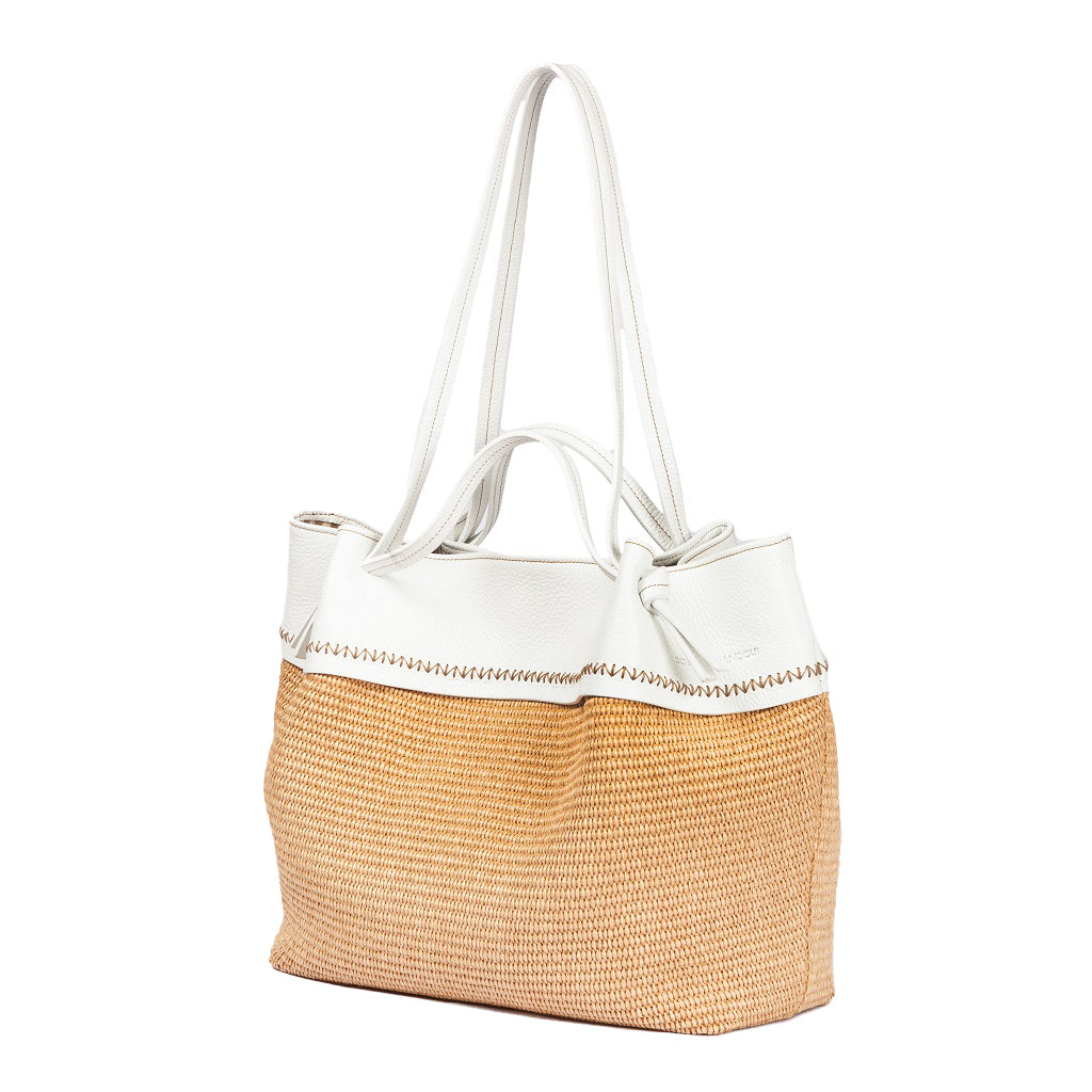 Tan and white woven tote bag with leather handles