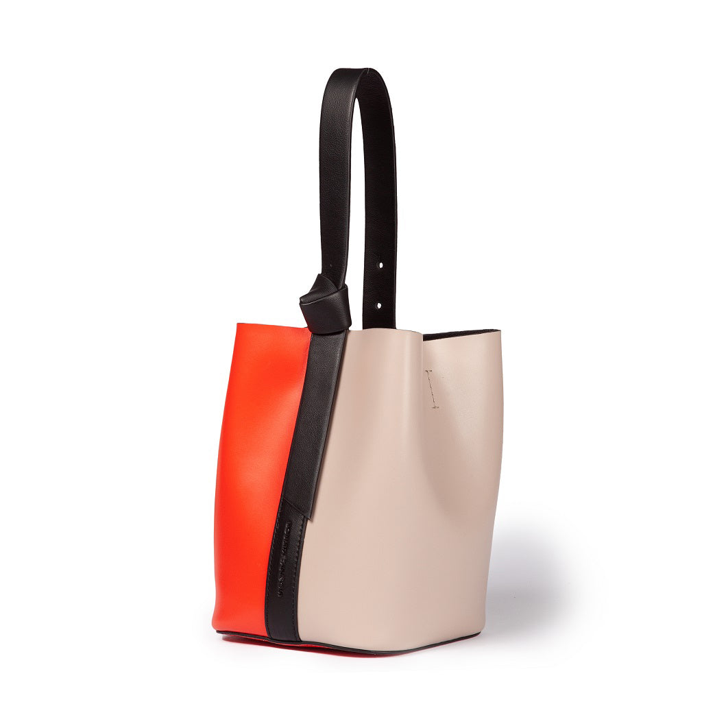 Color-block leather tote bag with red, beige, and black design