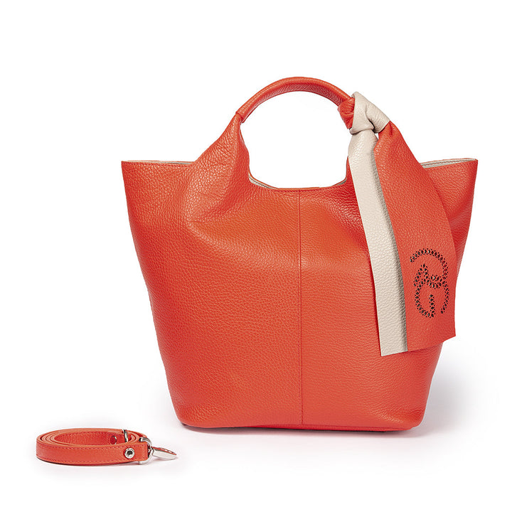 Stylish orange leather handbag with removable strap and decorative beige scarf