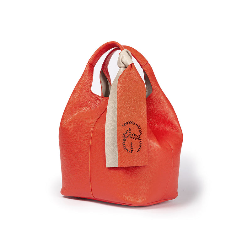 Luxurious orange leather handbag with white and orange hanging tags