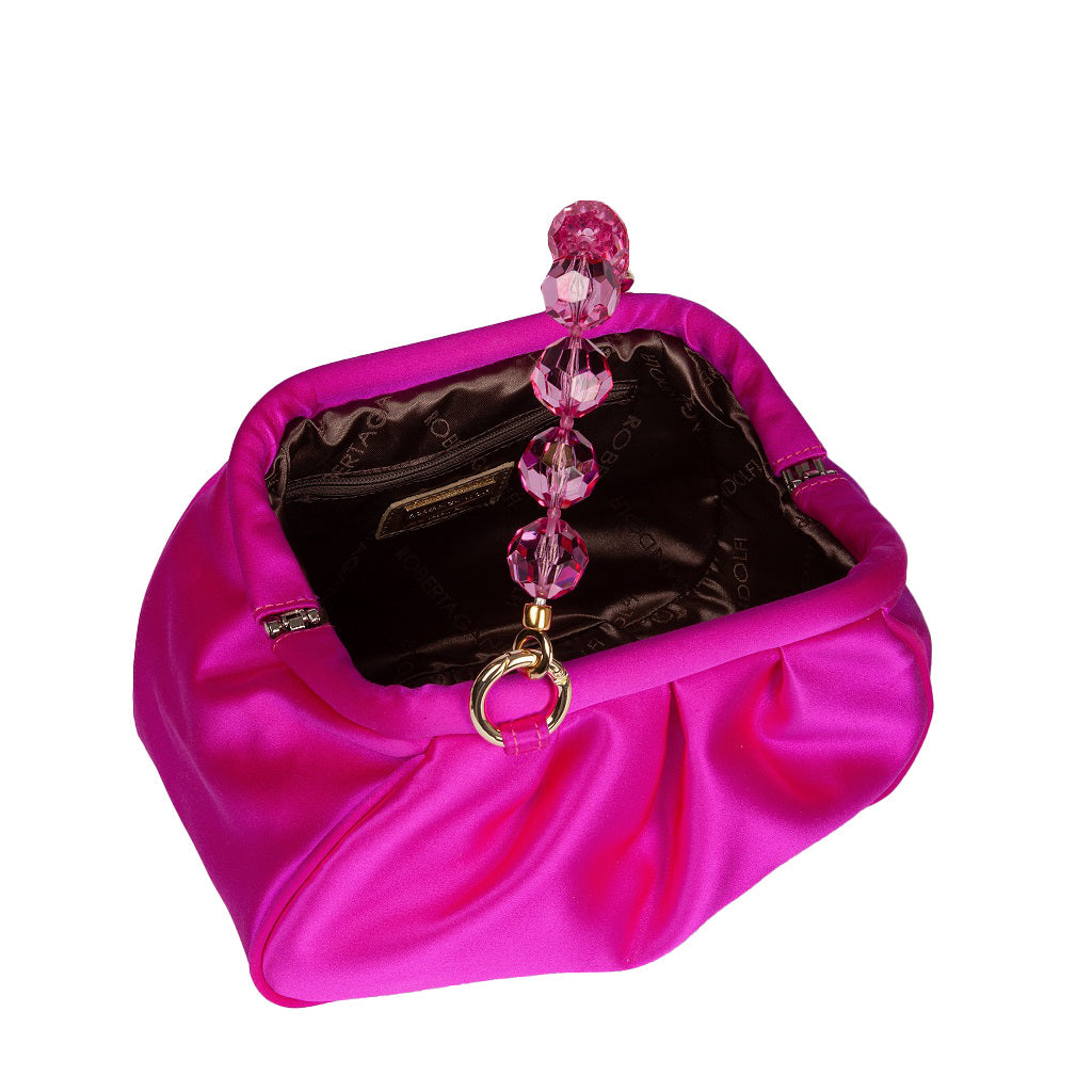 Bright pink satin clutch bag with an elegant beaded handle featuring five pink crystal beads, showing the interior lining