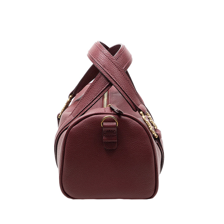 Side view of a maroon leather handbag with a gold zipper and adjustable strap