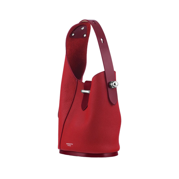 Red leather designer bucket bag with silver hardware and a top handle