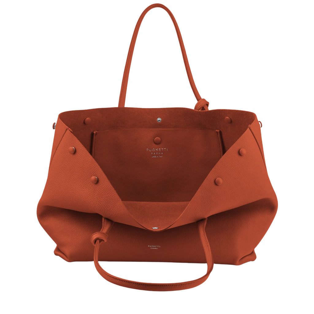 Minimalist orange leather tote bag with open interior and shoulder straps