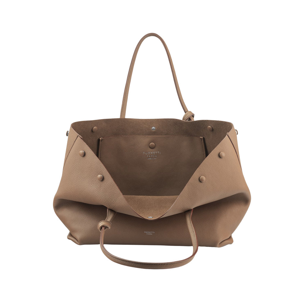 Tan leather tote bag with open top and interior compartments