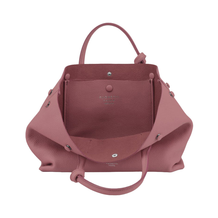 Pink leather handbag with open interior and silver hardware