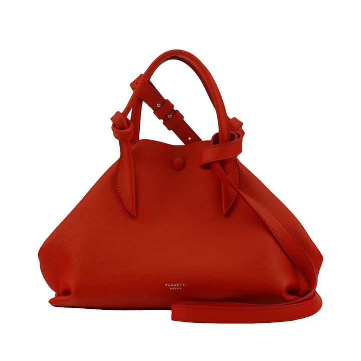 Red leather handbag with a unique knotted strap and minimalist design