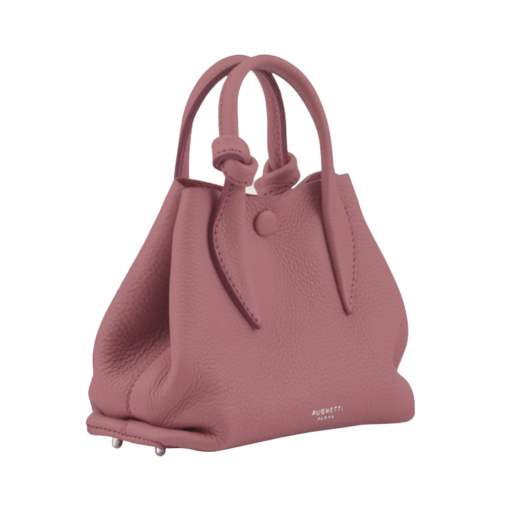 Dusty pink leather handbag with dual handles and a minimalistic design