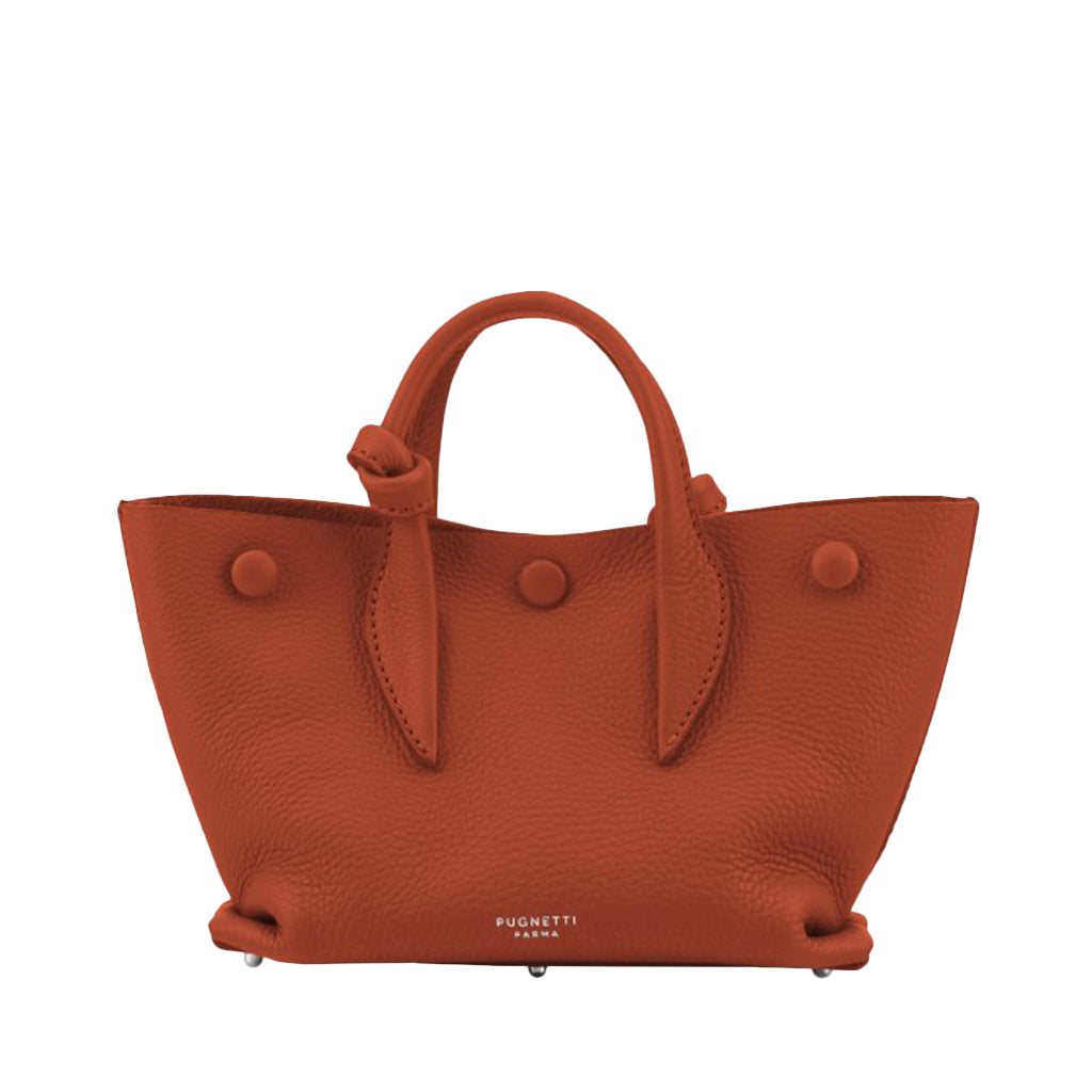 Rust orange leather handbag with handles and buttons