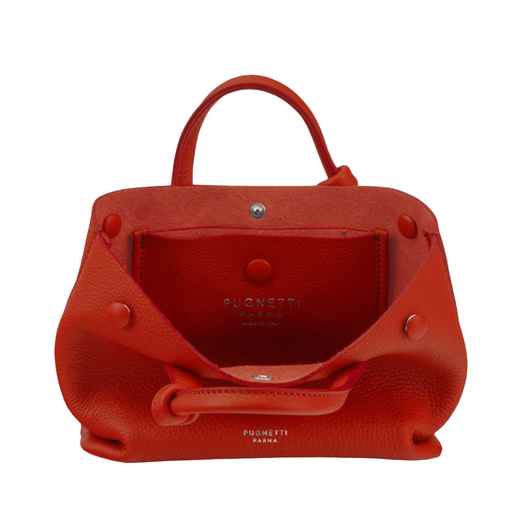 Open red leather handbag with visible brand label inside