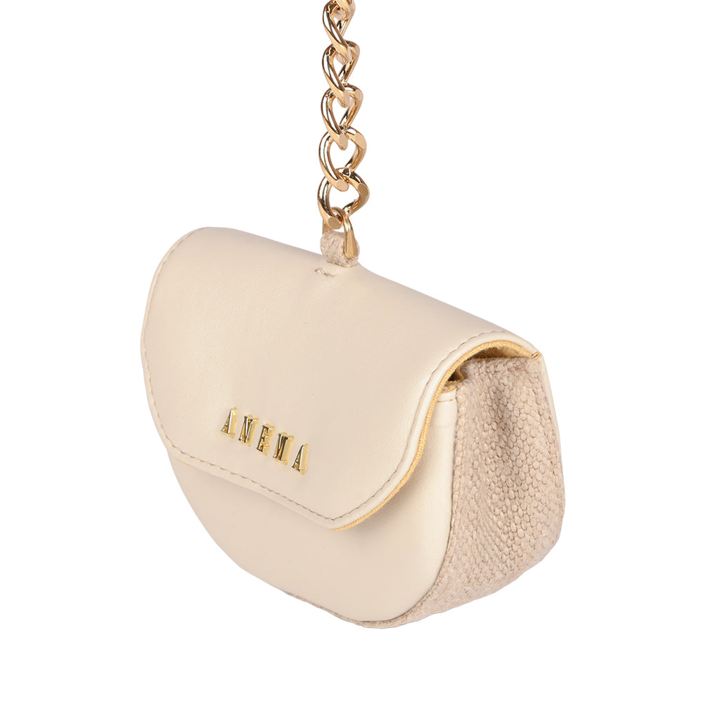 Elegant cream leather mini handbag with gold chain strap and textured side panels