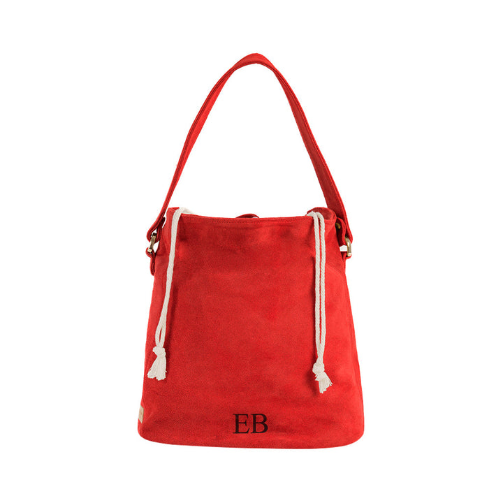 Red suede bucket bag with white drawstrings and EB initials