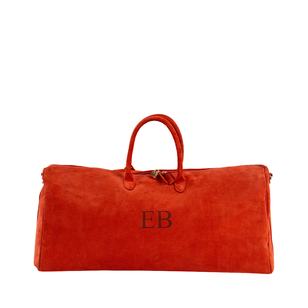 Large orange suede duffle bag with monogrammed initials
