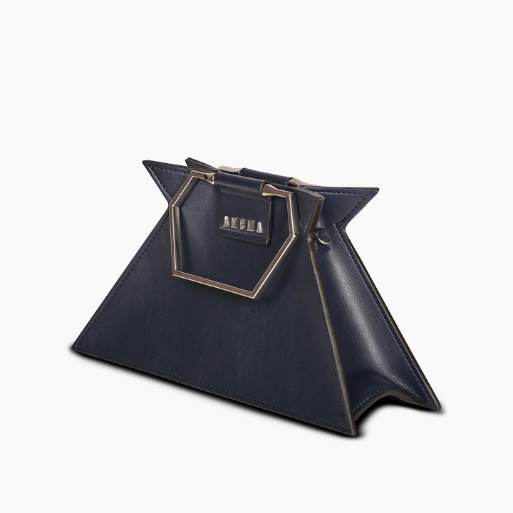 Navy blue geometric handbag with gold handles and designer label